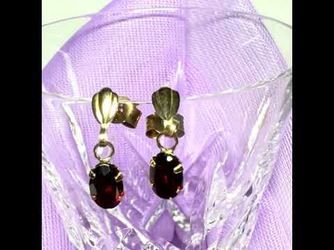 Video of a pair of real red garnet drop earrings oval shaped yellow gold