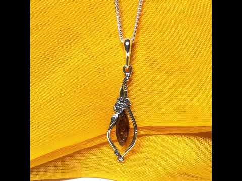 Real amber oval sterling silver necklace with a swirl set fancy patterned open pendant
