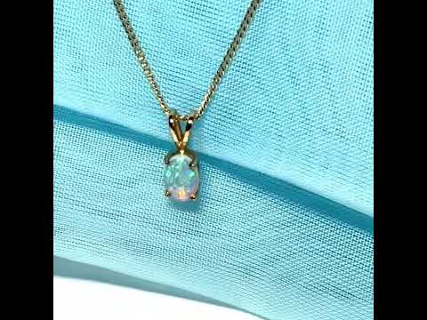 Real opal pendant oval yellow gold