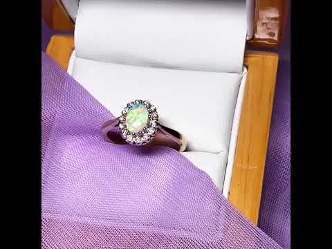 Video of a Real oval opal and diamond yellow gold cluster ring