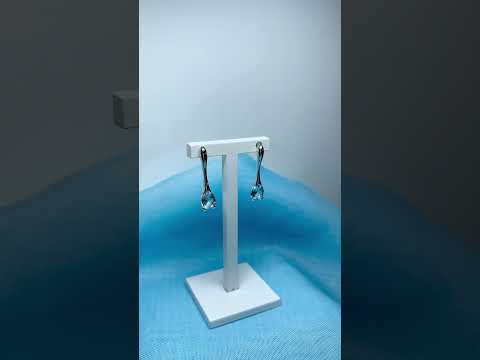 Video of a pair of real blue topaz sterling silver long drop earrings pear shaped stones