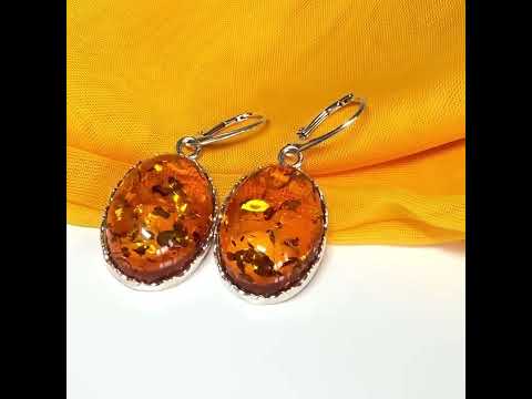 A pair of real amber drop earrings oval shaped sterling silver continental wire fittings