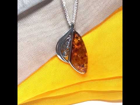 A Sterling silver real amber irregular marquise shaped necklace swirled open pendant