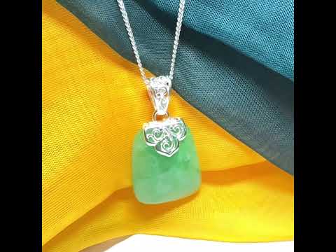 Green real jade necklace with a large shaped and patterned pendant
