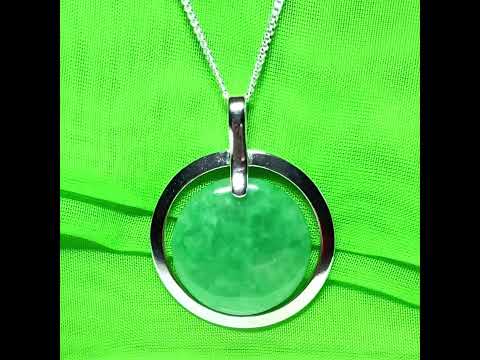 A large sterling silver round shaped green real jade necklace halo style, a traditionally designed pendant
