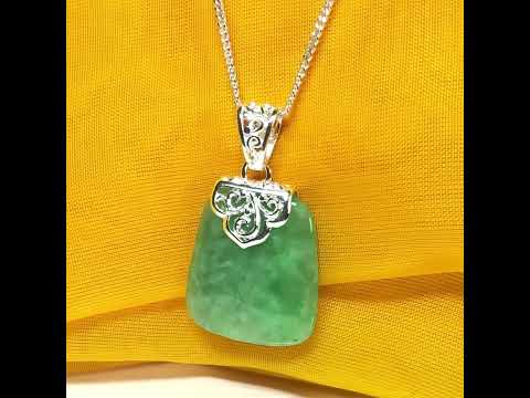 A real green jade necklace sterling silver large cushion shaped including a curb chain, a beautiful pendant