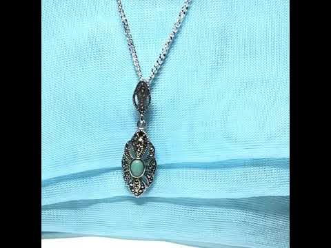Video of an oval turquoise and marcasite drop sterling silver necklace pendant
