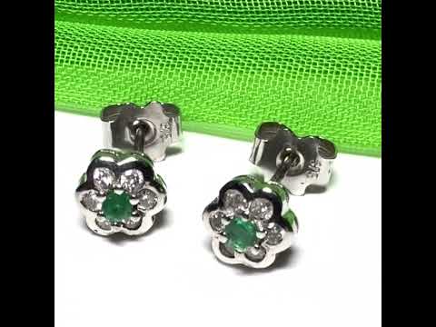 Video of a pair of Real emerald and diamond stud earrings white gold round daisy cluster