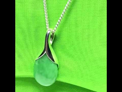 A gorgeous real green jade necklace in a tear drop or pear shaped with a chain as well