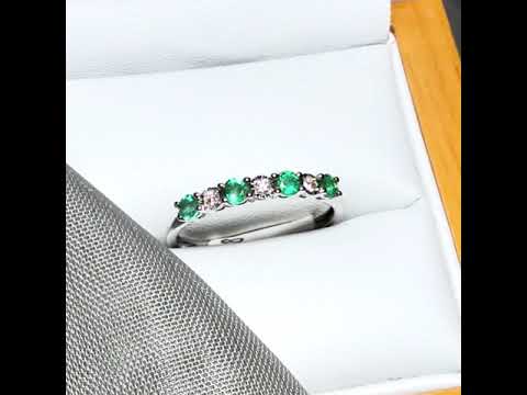 Video of a A real emerald and diamond white gold eternity ring claw setting