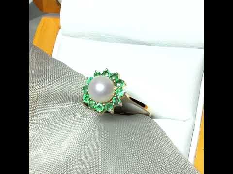 A video of a real cultured pearl and real emerald yellow gold round cluster ring