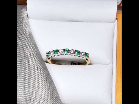Video of a stunning real emerald and diamond yellow gold eternity ring claw setting