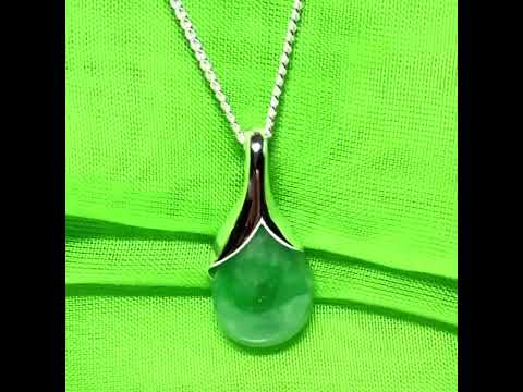 A real green jade necklace in a teardrop or pear shape, a traditional pendant