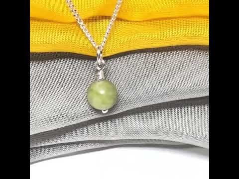 A small real green gypsum necklace ball shaped, a traditional round pendant