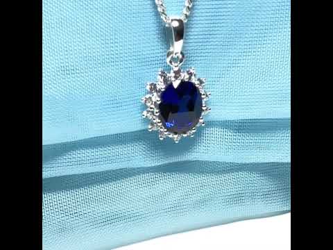 Oval cut deep blue cubic zirconia

Including chain

Round cut cubic zirconia stones

Gift box included

A beautiful large deep sapphire blue cubic zirconia cluster necklace pendant, with a deep blue oval cut cubic zirconia stone to the centre, set in sterling silver with fourteen round cut white cubic zirconia stones set around it

In an oval cluster pendant design

Measuring 22 mm in height

Measuring 13 mm in width