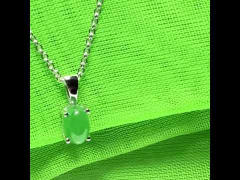 An oval shaped real green jade necklace white gold including chain