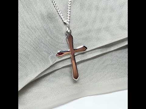 A solid sterling silver cross necklace fancy shaped pendant with a chain