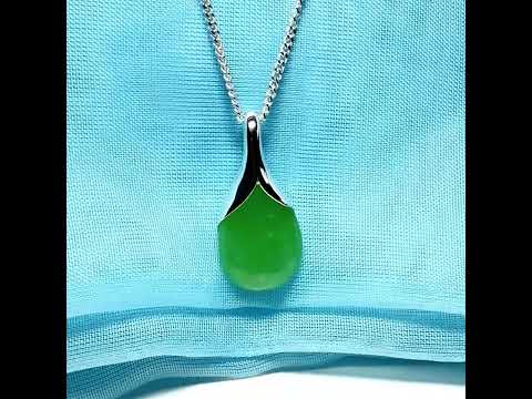 A real jade pendant in a teardrop shape or pear shaped designed green necklace including chain