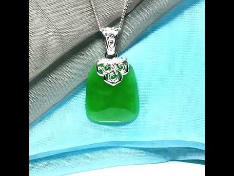 A stunning real green jade necklace with a large shaped and patterned pendant