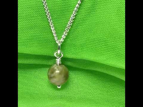 A small real green gypsum round necklace ball shaped, a traditional pendant