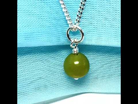 A gorgeous small real green gypsum necklace ball shaped, a really gorgeous round pendant with chain too