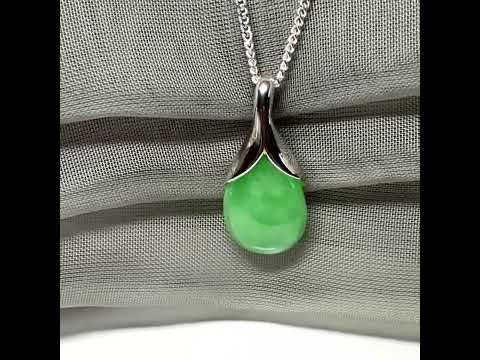 A real green jade necklace in a teardrop or a pear shape with a solid chain included