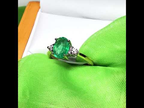 Video of a 1.15 carat real green emerald and diamond 18 carat yellow gold oval trilogy dress ring