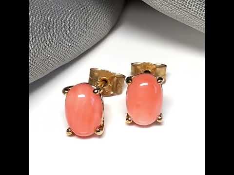 A pair of real coral oval shaped stud earrings yellow gold claw set
