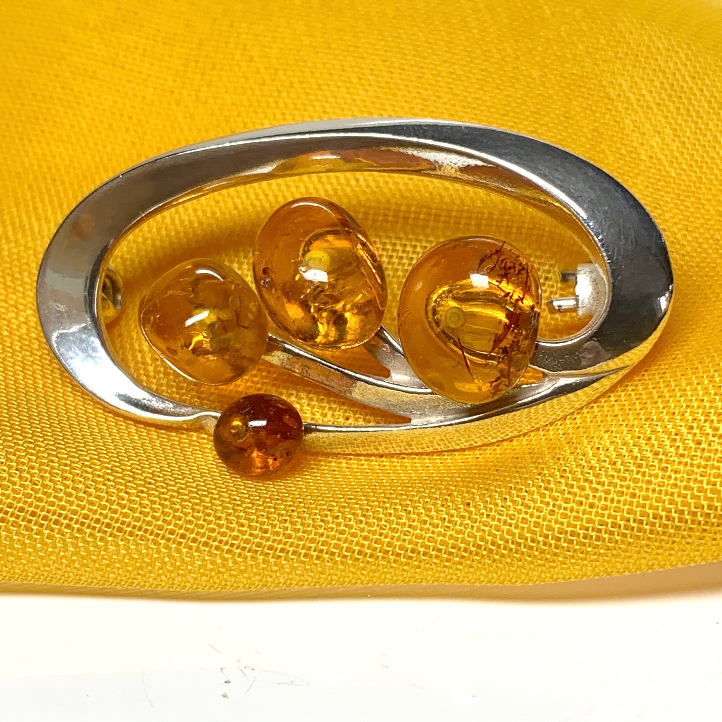 Sterling silver oval swirl fancy amber brooch