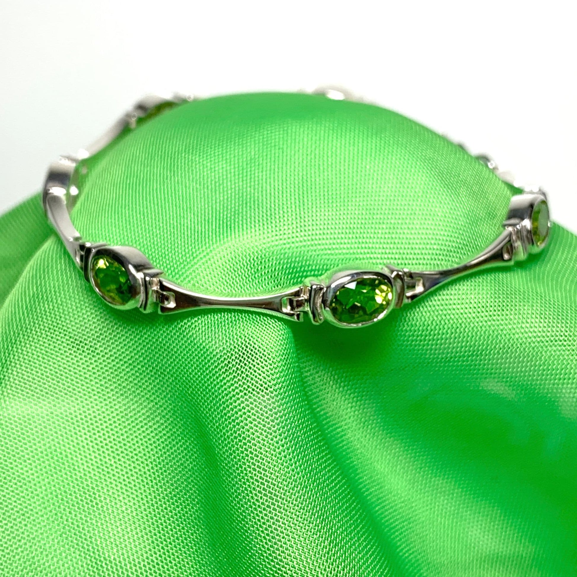 Silver peridot bracelet with oval green precious stones