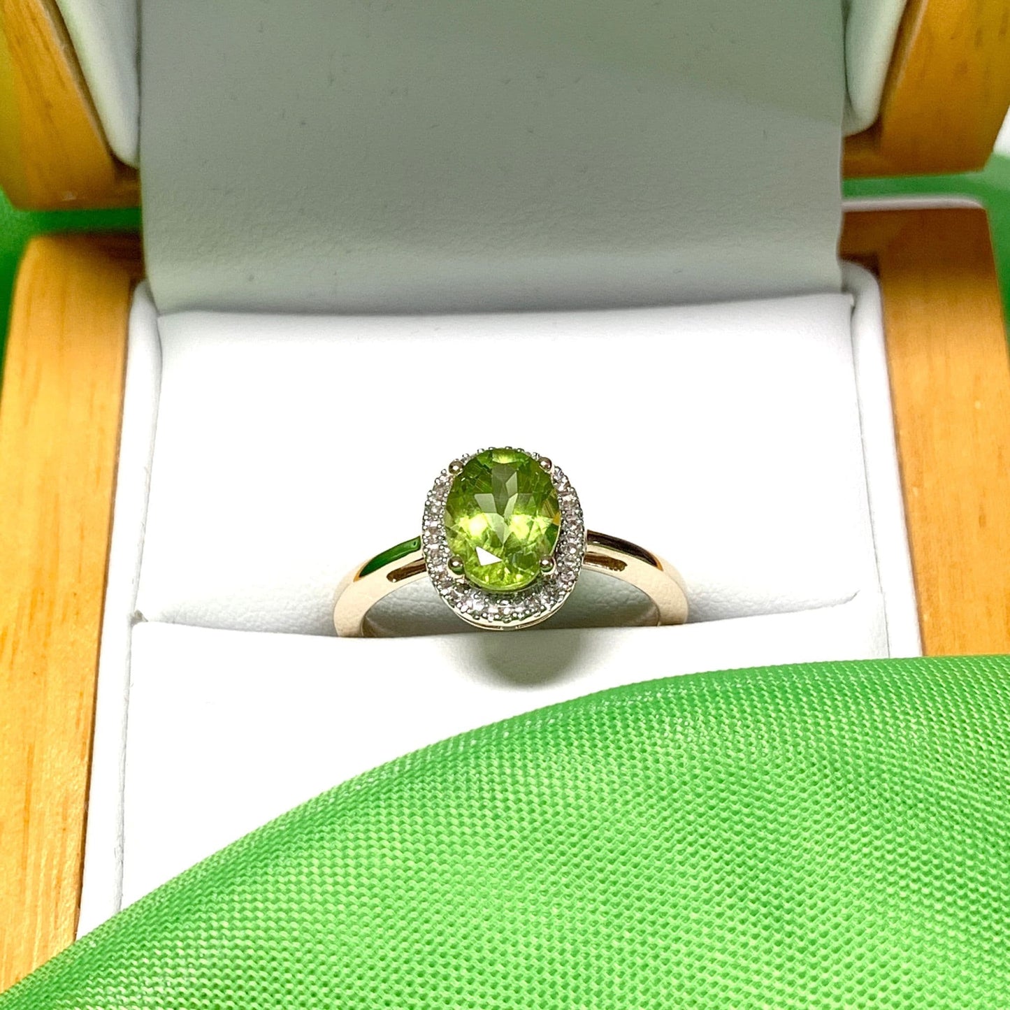 Peridot and diamond yellow gold oval cluster ring